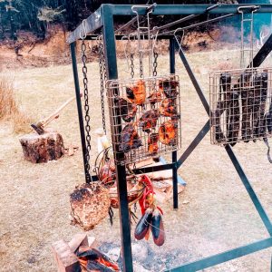Cooking chicken and veggies over open fire at the Hut at High Peak Station